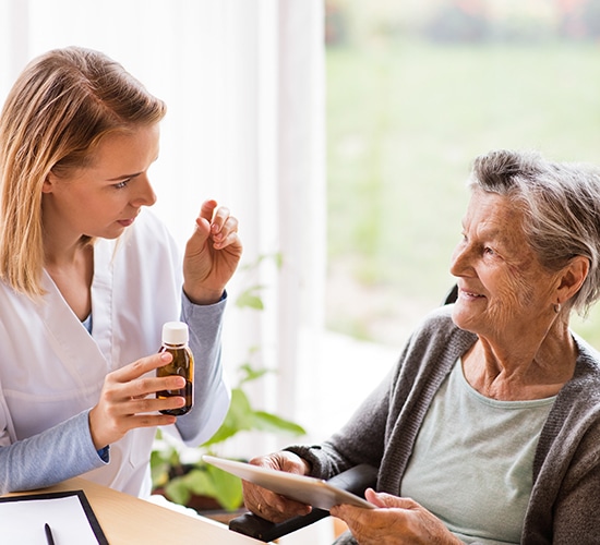 caregiver providing a medication review with senior patient